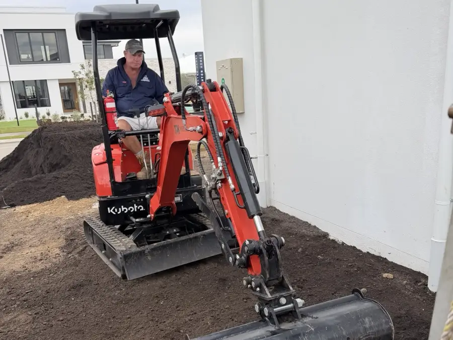 Mini excavator moving soil during site preparation