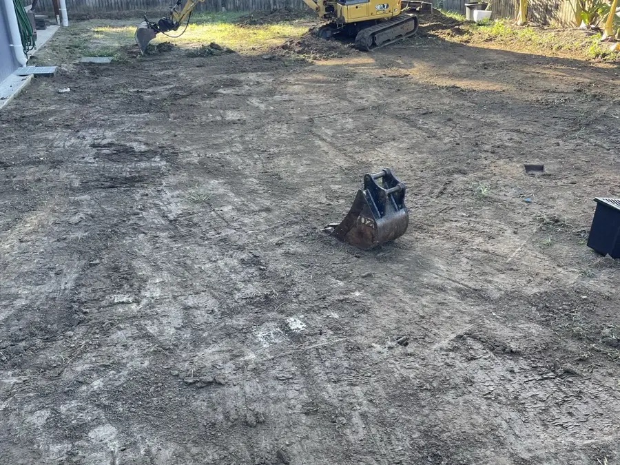 Backyard graded to bare soil before turf was laid